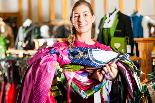 Mujer está comprando Tracht o dirndl en una tienda — Foto de Stock