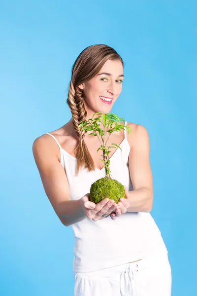 Young Woman holding a small tree — Stock Photo, Image