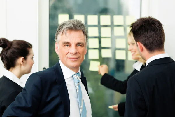 Business Team with leader in office — Stock Photo, Image