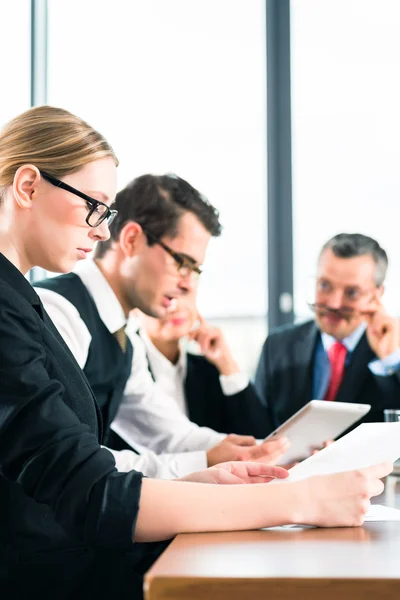 Team working with tablet at meeting in office — Stock Photo, Image