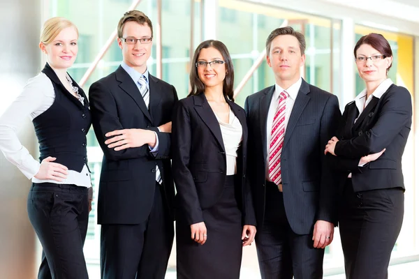 Business - group of businesspeople in office Stock Picture