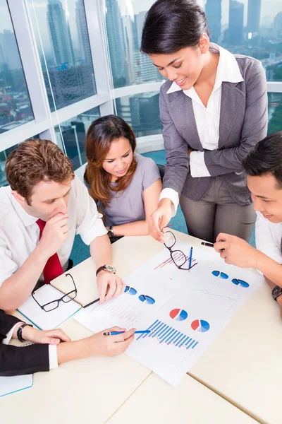 Asian Business team discussing charts — Stock Photo, Image