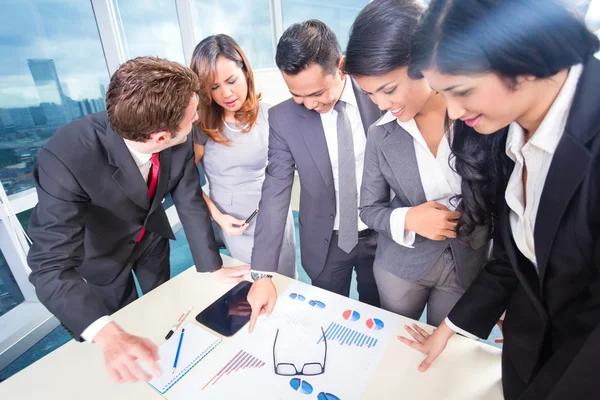 Gemengd bedrijf team bespreken winst — Stockfoto