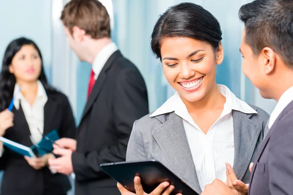 Asian Businesspeople having meeting in office Stock Image