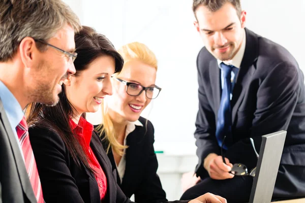 People in office working as team Stock Image