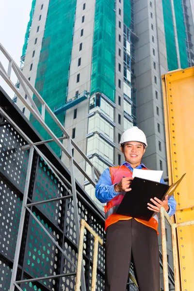 Asian worker or supervisor on building site — Stock Photo, Image
