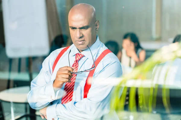 Indischer Geschäftsmann denkt am Bürofenster — Stockfoto