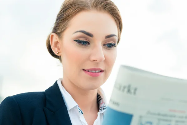 Business woman reading business newspaper — стоковое фото