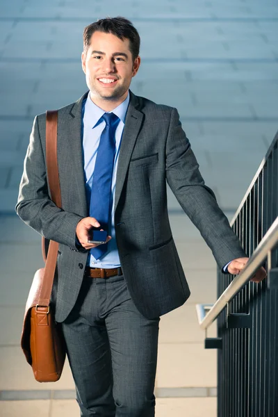 Businessman walking using phone — Stock Photo, Image