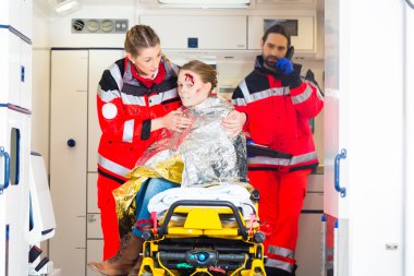 Ambulance helping injured woman clipart