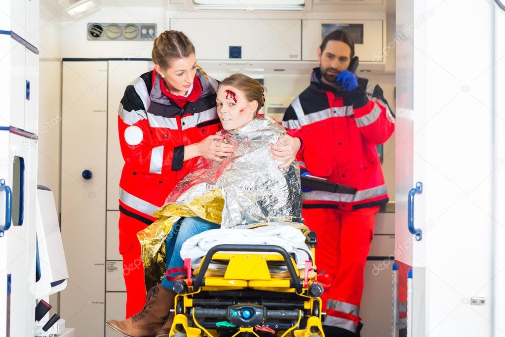 Ambulance helping injured woman