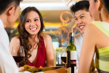 Chinese business people dining in restaurant