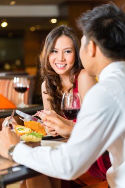 couple having romantic dinner in fancy restaurant