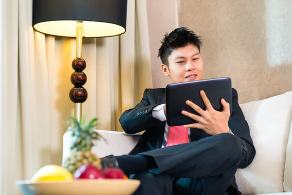 Zakenman in hotelkamer werken met Tablet PC — Stockfoto