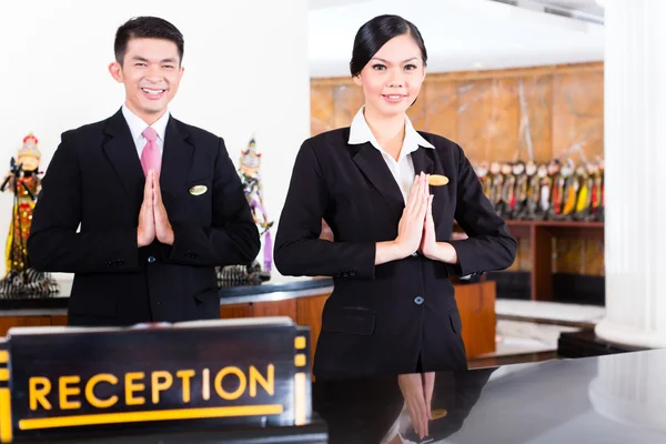 Reception team at hotel reception desk — стоковое фото