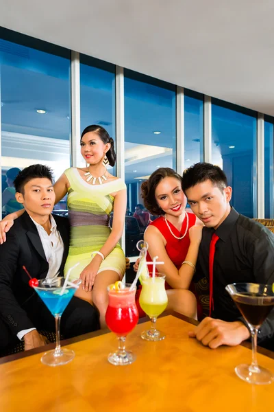 people drinking cocktails in luxury bar