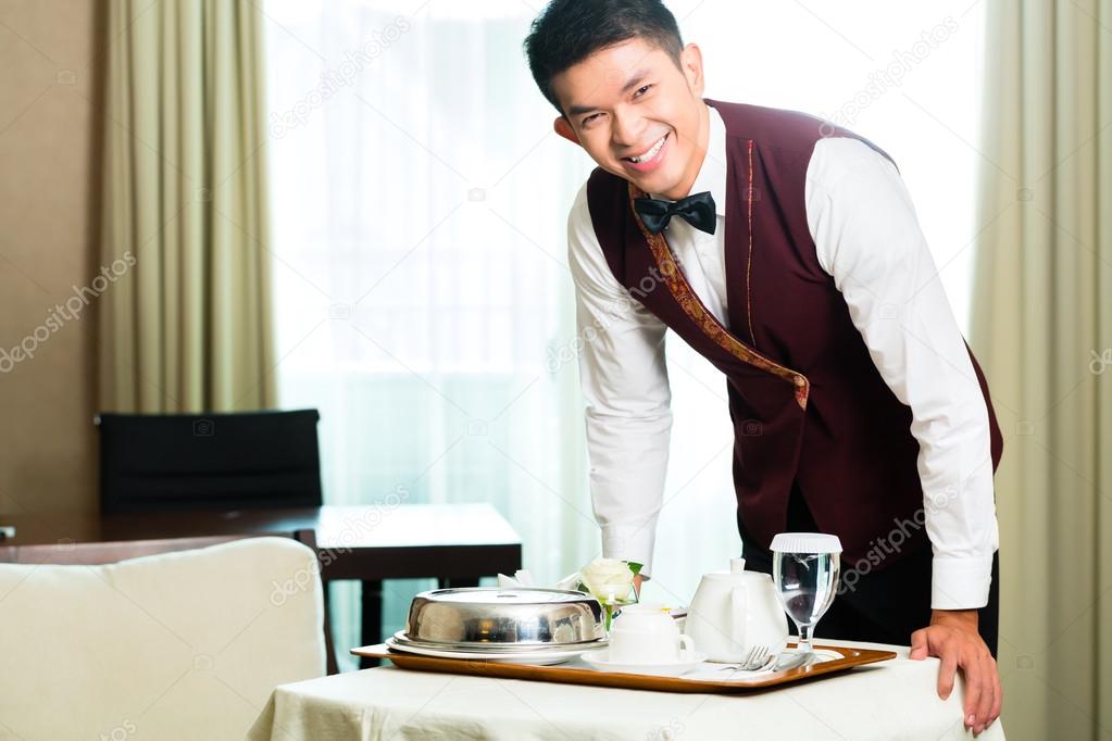 room service waiter serving food in hotel