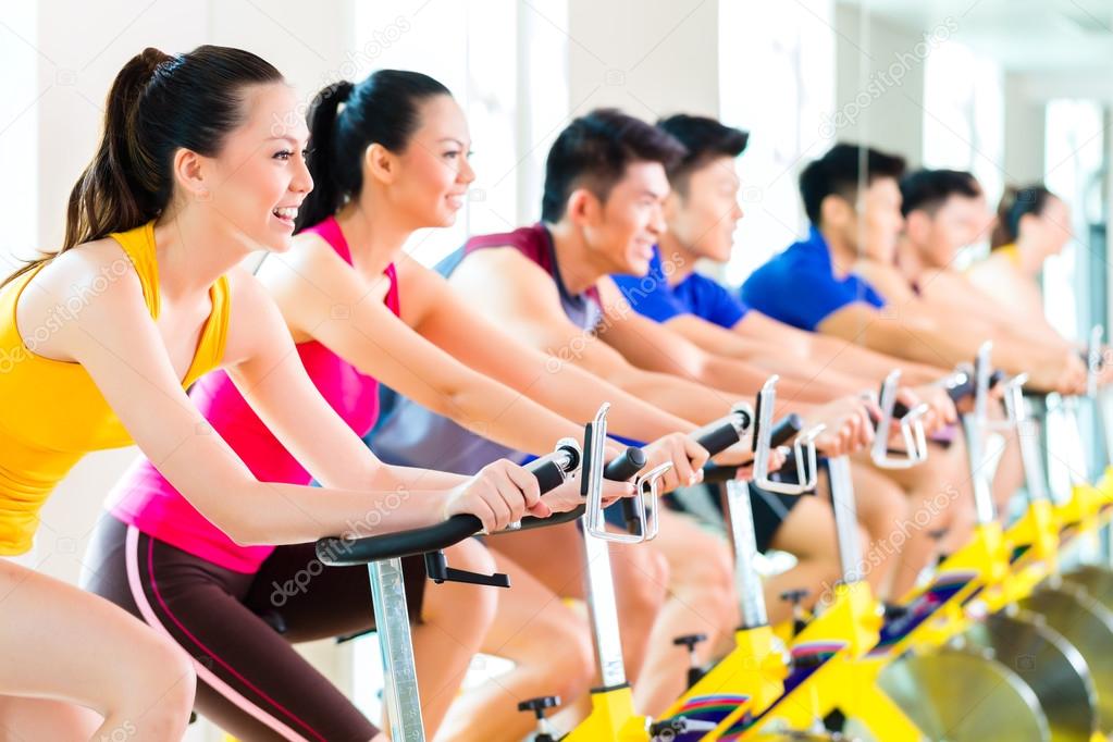 people spinning bike training at fitness gym