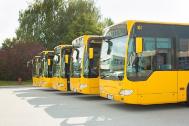 Busses parking in row on bus station or terminal clipart