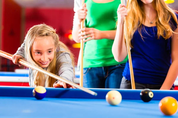 Girl playing pool billiard with family — Stock Photo, Image