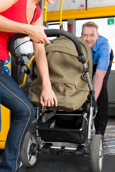 Woman with stroller getting into a bus — Stock Photo, Image