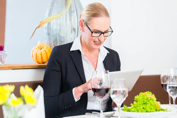 Mujer de negocios con tablet en restaurante — Foto de Stock