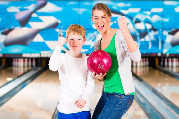 Mother and son playing together at bowling center Stock Picture