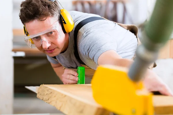 Carpenter using electric saw in carpentry — Stock Photo, Image