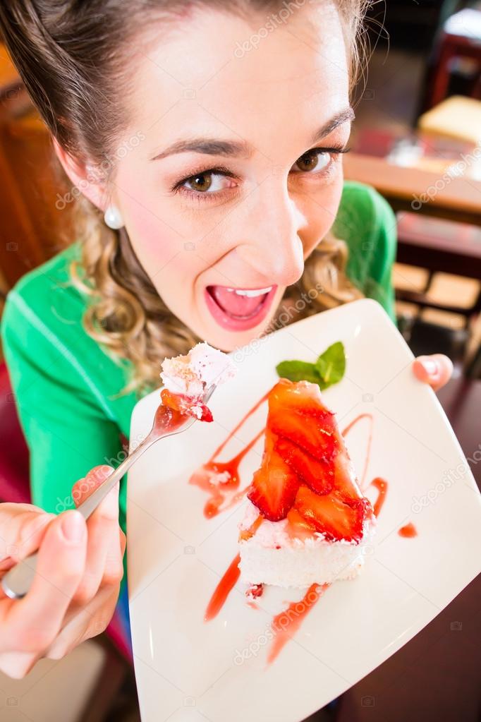 Woman eating cake at pastry shop cafe Stock Photo by ©Kzenon 79203338