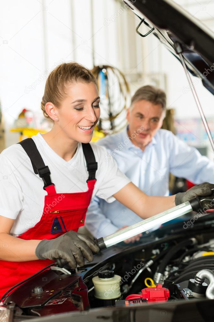 man and female car mechanic in workshop