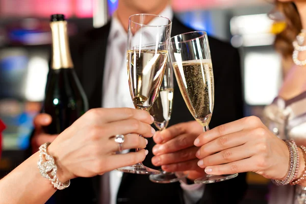 People with champagner in a bar — Stock Photo, Image