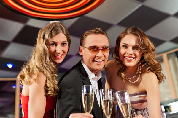 People with champagner in a bar — Stock Photo, Image