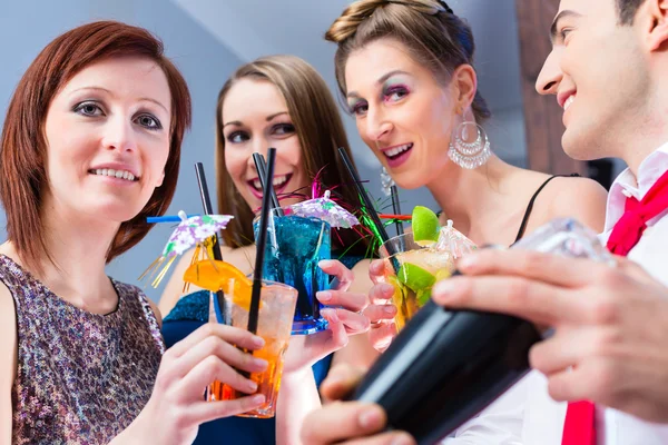 Freunde feiern mit Barkeeper in Cocktailbar — Stockfoto