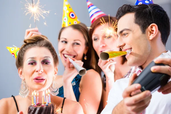 Friends having or new years eve birthday celebration — Stock Photo, Image