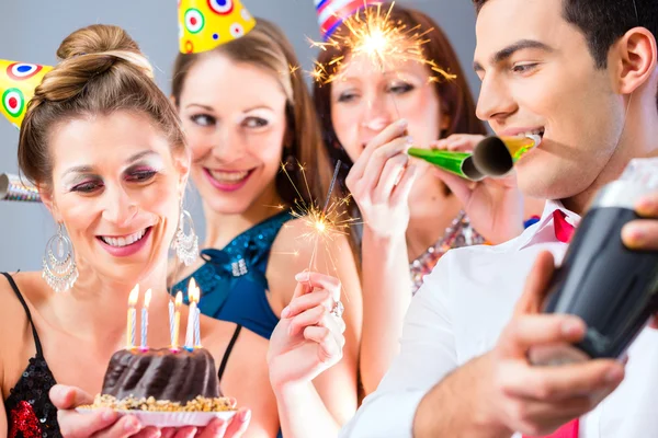 Friends having or new years eve birthday celebration — Stock Photo, Image