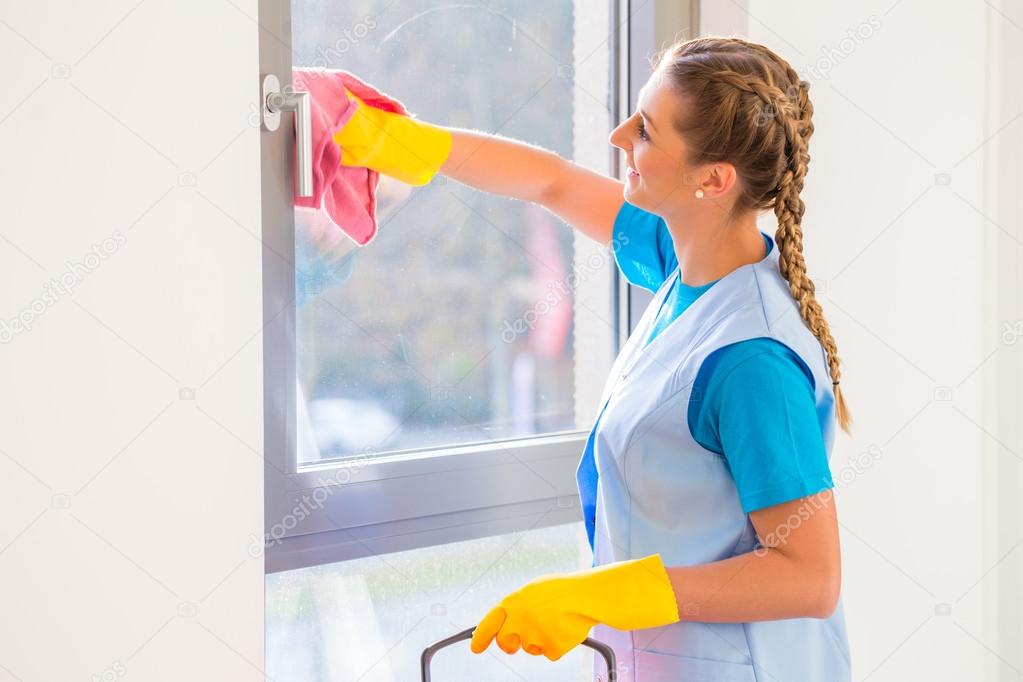 Cleaning lady with cloth at window