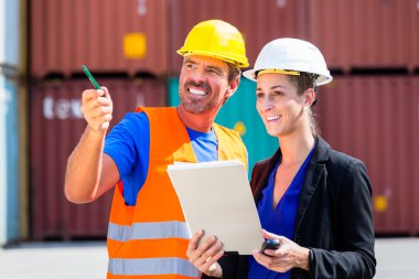 Employees in logistics company shipping containers