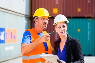 Employees in logistics company shipping containers