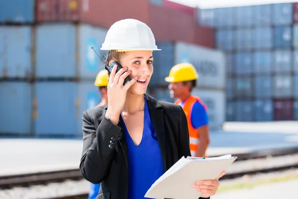 Manager with phone talking on shipment yard — Stock Photo, Image