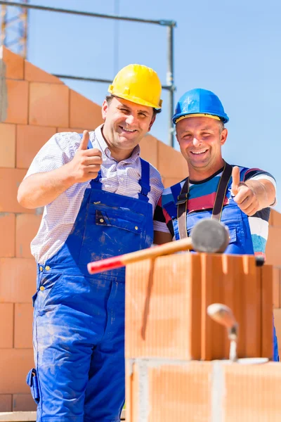 Trabajadores del sitio de construcción construyendo paredes en casa —  Fotos de Stock