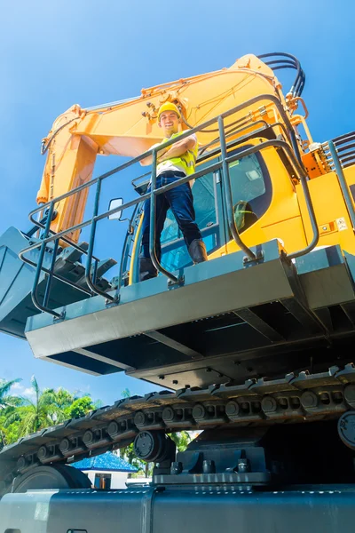 Ásia construção trabalhador no pá escavadeira — Fotografia de Stock