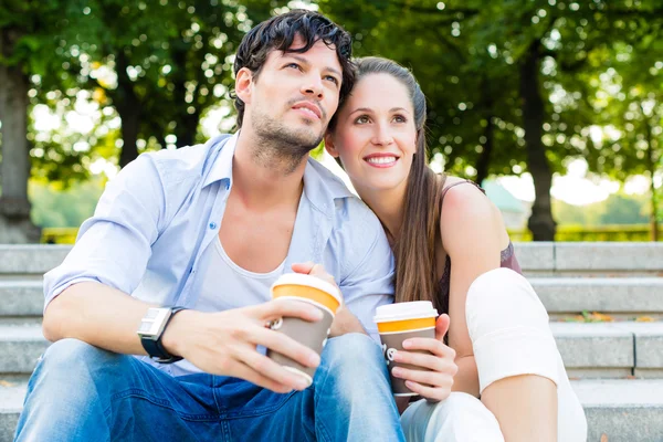 Couple in city park drinking coffee — Stock Photo, Image