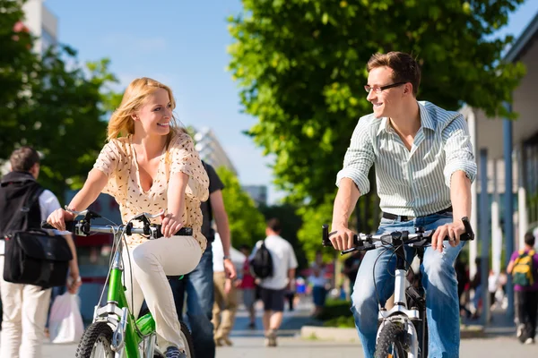 Urban couple riding bike in city