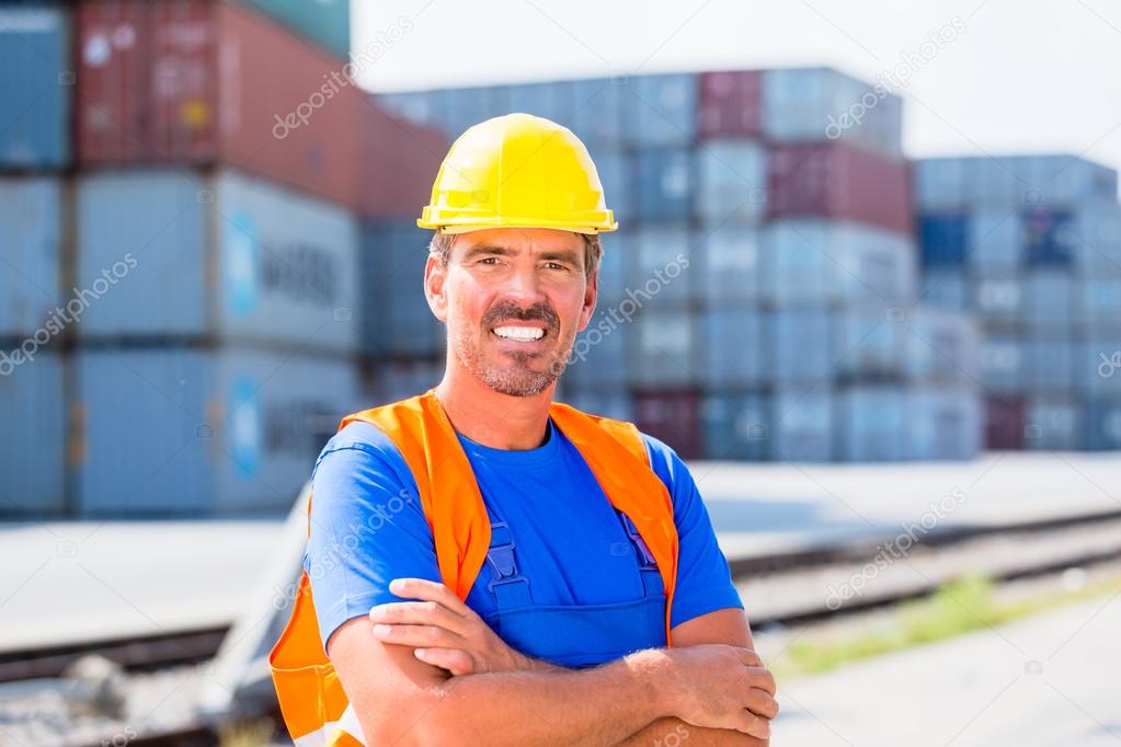 Worker and row of containers on port