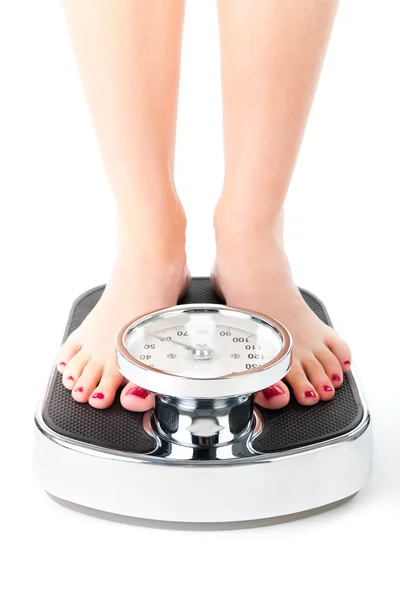 Young woman standing on a scale — Stock Photo, Image
