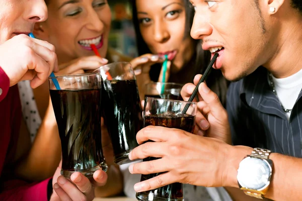 Friends drinking soda in a bar — Stock Photo, Image