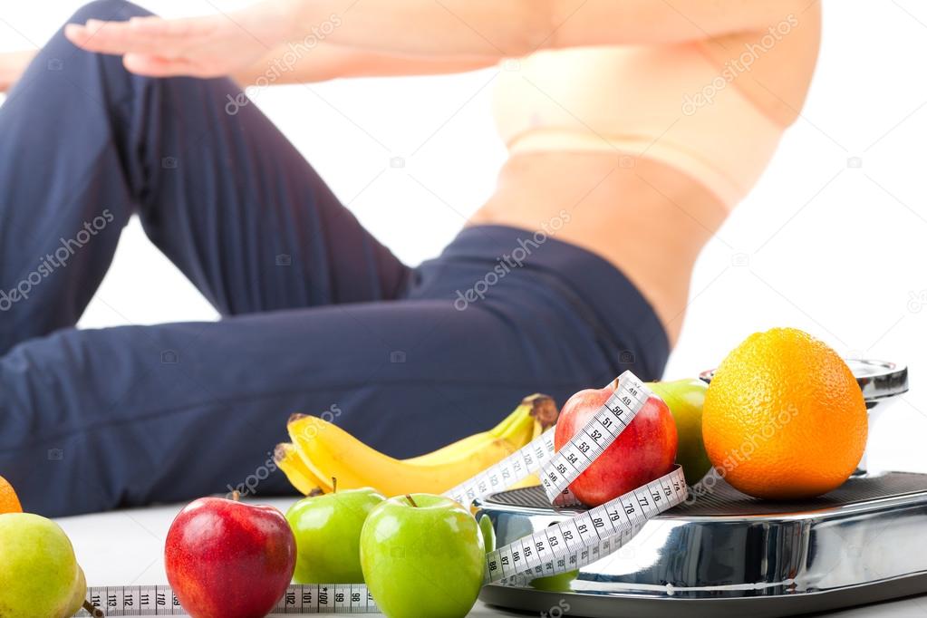 Diet and sport - woman is doing sit-ups