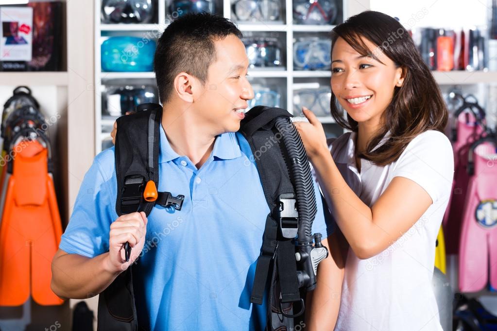 Customer buying equipment in divers shop