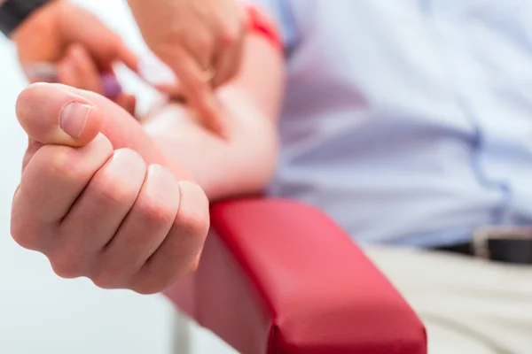 Doctor taking blood sample — Stock Photo, Image