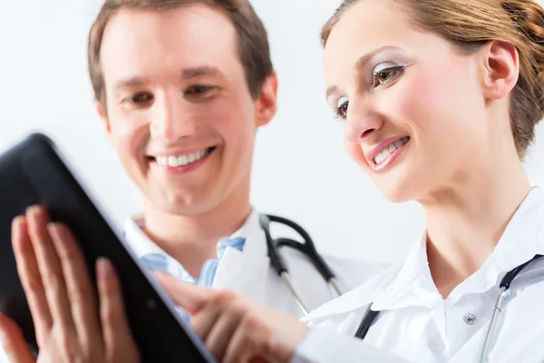 Team van artsen in de kliniek met tablet pc — Stockfoto